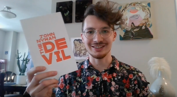 John Nyman holding a copy of The Devil, from his reading for KFB's spring 2020 online release party
